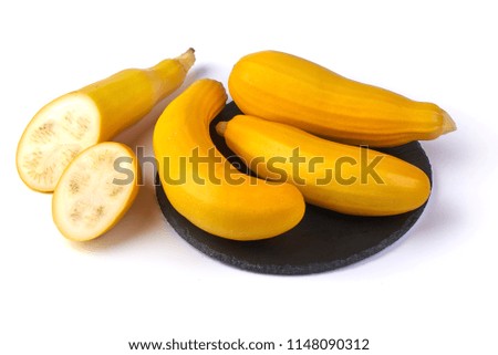 Yellow zucchini squash on the shale board, isolated on white background.