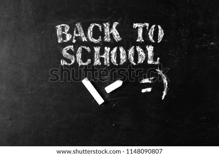 Back to school background. "BACK TO SCHOOL" text with white chalk on school blackboard with copy space.