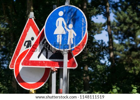 German road signs in front of natural background