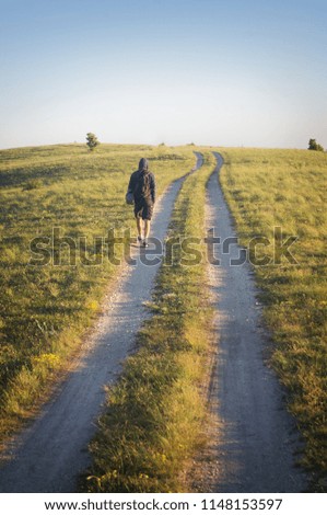 man walking on the road in the mountains