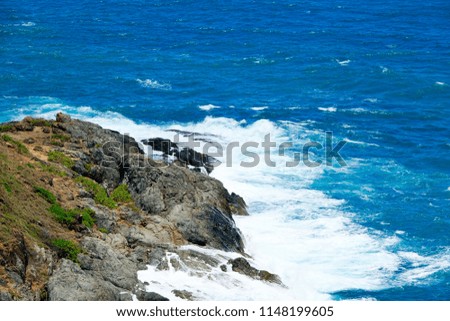 Selective close up Scenic View Of Beautiful Cliff And Cave with Colored Sea During Summer.