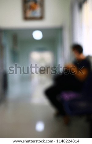 Silhouette and blurry background of people sit on the waiting area wait for contact a government transaction affair service.