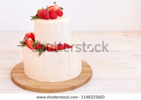 Big cake with strawberries and raspberries. Free space for text, recipe.