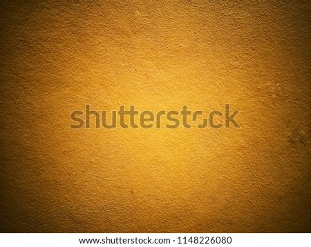 Wall made of cement painted texture with yellow gold color oil paint, background  
