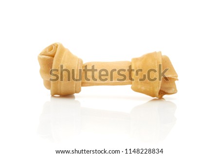 Close up of artificial bone treat for dog and healthy oral hygiene on white background
