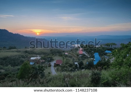 view of small houses on the hill with colorful of sun light in the sky backbround, sunset at Khao Kho, Phetchabun, Thailand