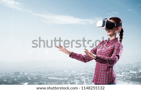 Young caucasian woman in virtual reality helmet against cityscape background