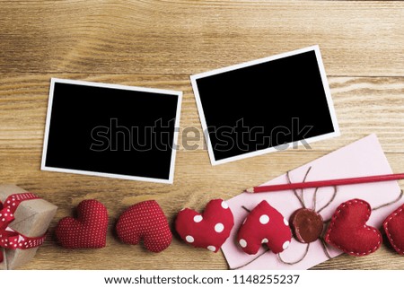 Blank instant photo and love hearts on wooden table background