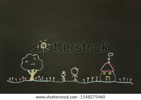Actual drawing on black chalk board. little house under clear sky sun with flowers and a tree