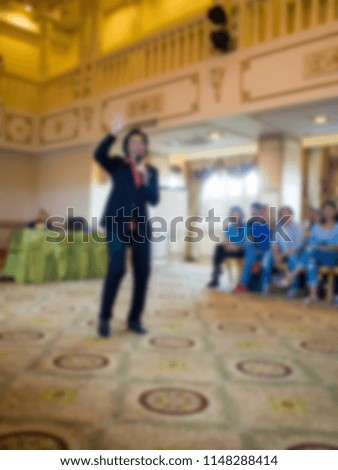 The host is describing the activities of the seminar to employees. Abstract image blur.