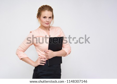 Portrait of a beautiful business blonde girl standing on a white background with a folder. She is right in front of the camera in different poses