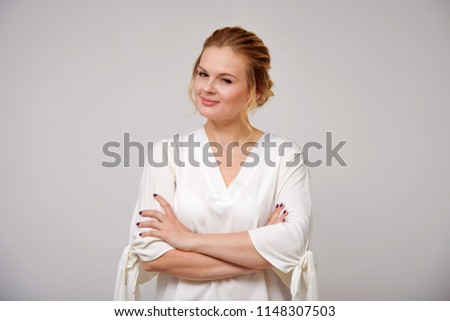 portrait of a beautiful blonde girl on a white background in different poses with different emotions. She is right in front of the camera smiling and looking happy