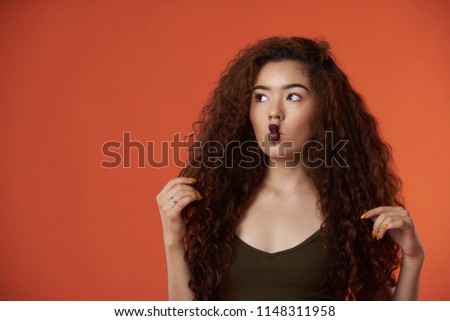 Girl with fish faces on orange color background