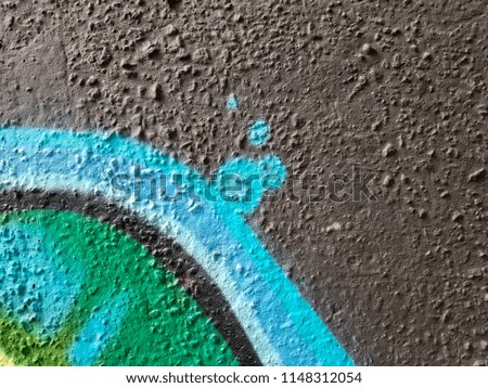 Fragment of colored abstract black wall paint in blue and green colors