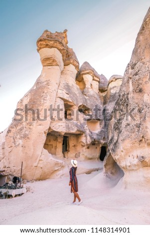 happy young couple on vacation in Turkey Cappadocia, Rock Formations in Pasabag Monks Valley, Cappadocia, Turkey