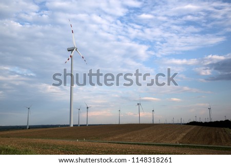Landscape with wind turbines and road in front during sunset, falling season, Austria, Europe
