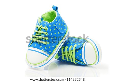 Spotted baby sneakers closeup isolated on white Royalty-Free Stock Photo #114832348