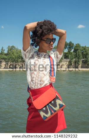 Street fashion concept. Portrait of elegant young beautiful woman. Paris buildings as background.