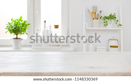 Empty table board and defocused modern kitchen window background concept