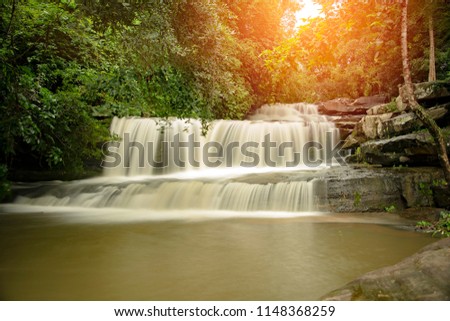 Than Thong Waterfall in Nong Khai Province, Thailand.
It is a popular place to relax with family during the weekend.(Add orange light to the beauty and prominence of the picture.)