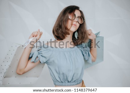 Portrait of attractive laughing woman with shopper bag in her hand. Beauty fashion smiling girl doing shopping. Let's go shopping concept. Copy space.