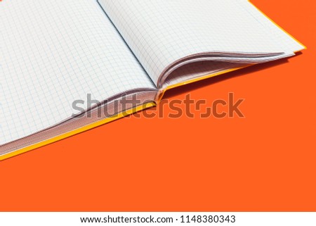 white opened workbook lying on an orange background. concept of business or educational equipment. free space for advertising text Royalty-Free Stock Photo #1148380343