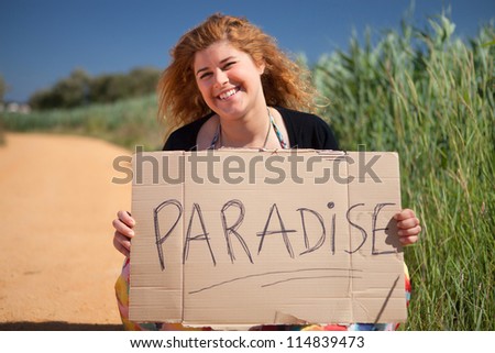 Pretty young woman holding a blank card