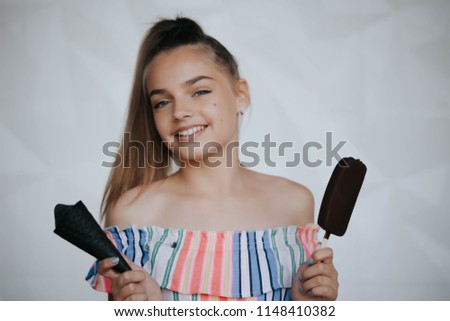 Happy girl eating ice cream. Young hipster girl eating a delicious ice cream in summer hot weathe. Chocolate. Cream. Ice. Sweet Tooth
