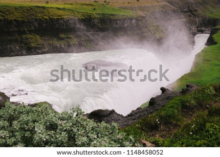 Breathtaking view of Gullfoss waterfall on a grey and cold summer day -famous landmark on the golden circle route in Iceland. Concept of nature power, powerful water flow