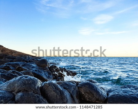 The turqoise water crashing in over the rocky shores of southern Norway