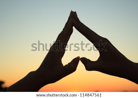 silhouette hand in heart shape