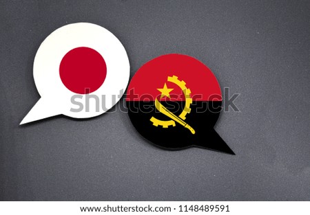 Japan and Angola flags with two speech bubbles on dark gray background