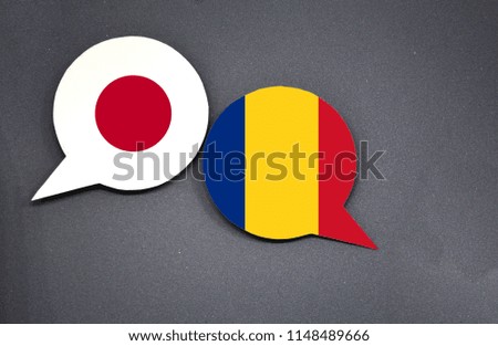 Japan and Romania flags with two speech bubbles on dark gray background