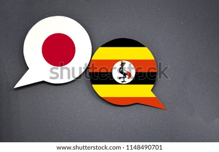 Japan and Uganda flags with two speech bubbles on dark gray background