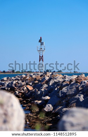 Small lighthouse in the Aegean sea. Greece seascape	
