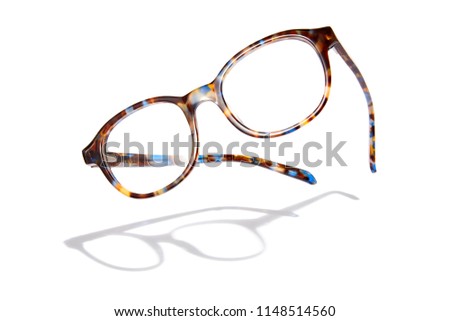 Advertising photo of flying glasses with shadow. Isolated on white background.