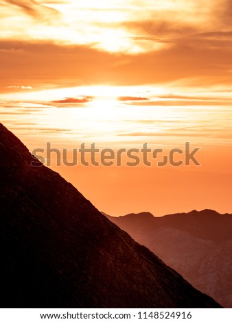 dramatic sunset behind mountain range, mountain silhouette swiss alps brienzer rothorn
