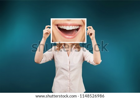 Woman holding picture with big smile