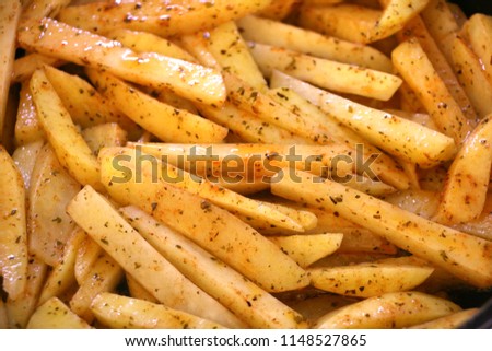Raw cut potatoes before cooking, home made french fries already to cook.Selective focus Royalty-Free Stock Photo #1148527865