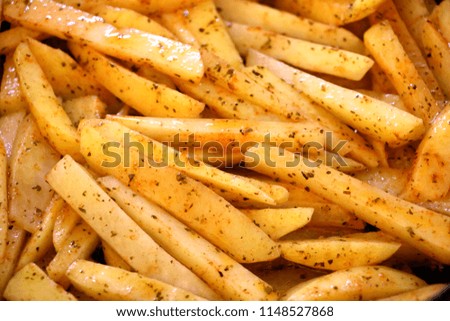 Raw cut potatoes before cooking, home made french fries already to cook.Selective focus Royalty-Free Stock Photo #1148527868