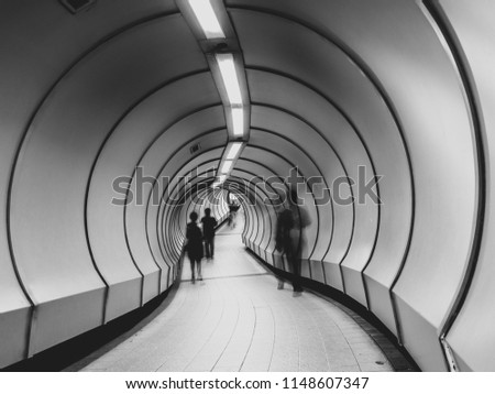 This is a photo of a tube tunnel in with curved path.