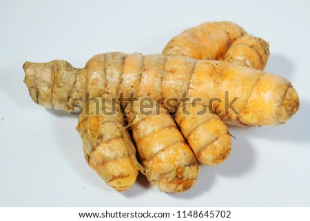 A close up picture of turmeric. Turmeric is a rhizomatous herbaceous perennial flowering plant of the ginger family, Zingiberaceae.