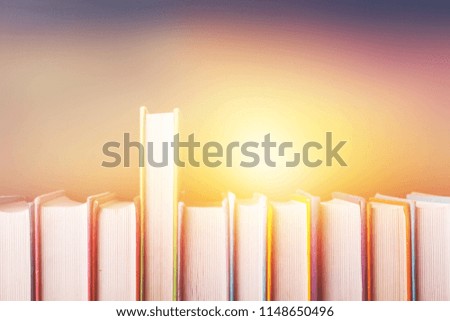 Old books in row on dark background