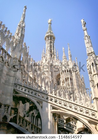 Massive Gothic Cathedral roof top with huge amount of artwork know as Duomo di Milano