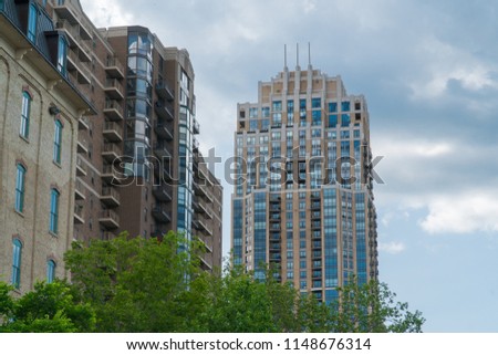 Establishing shot outside waterfront riverside luxury apartment buildings in urban city. Expensive real estate development in population growth areas of the united states