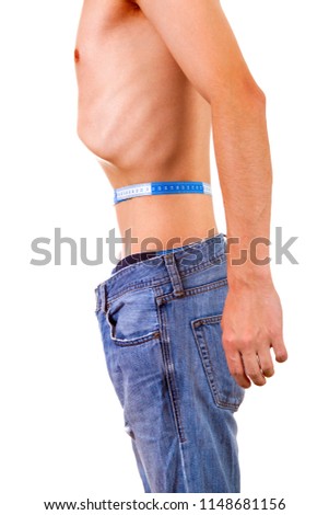 Skinny Man measure his Waist on the White Background Royalty-Free Stock Photo #1148681156
