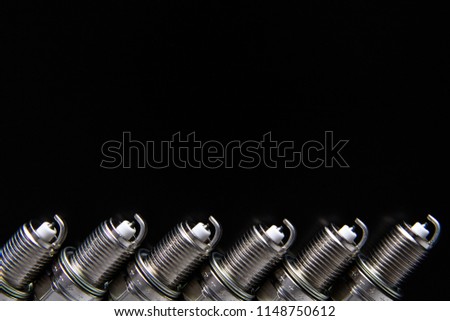 New spark plug isolated on a black background