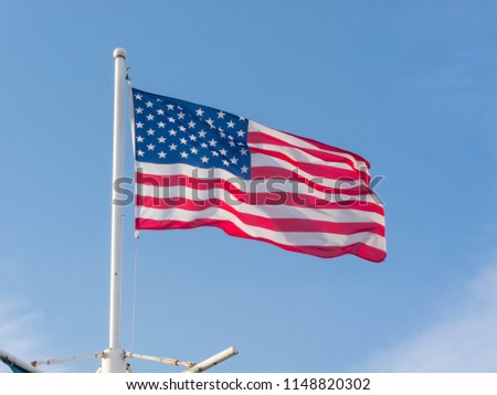 Flag of the United States on the blue sky
