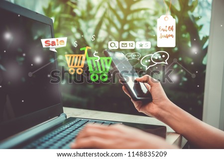 Women hand using smartphone and laptop do online selling for people shopping online with chat box, cart, dollar icons pop up. Social media maketing concept.