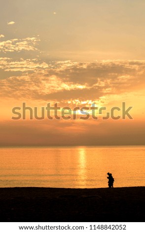 People stood watching the sea, Sunrise and happy